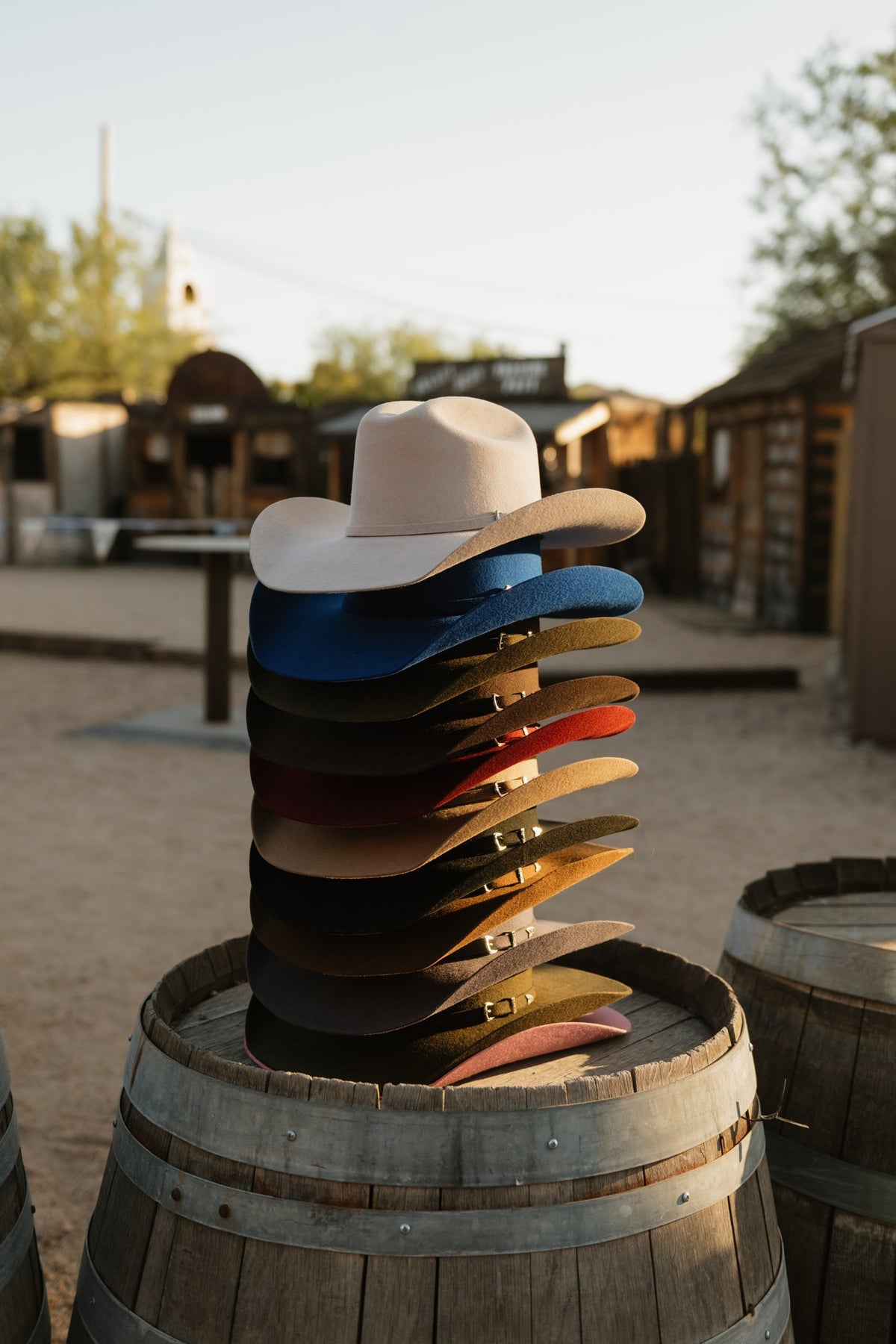Stack of Tailor Hats in many colors on a barrel